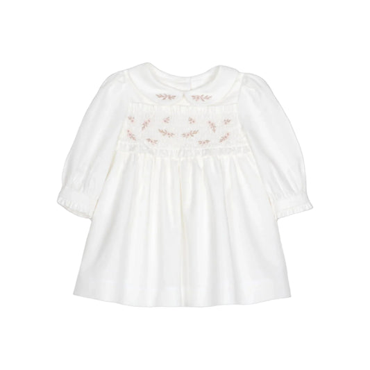 White blouse with floral embroidery on a black background