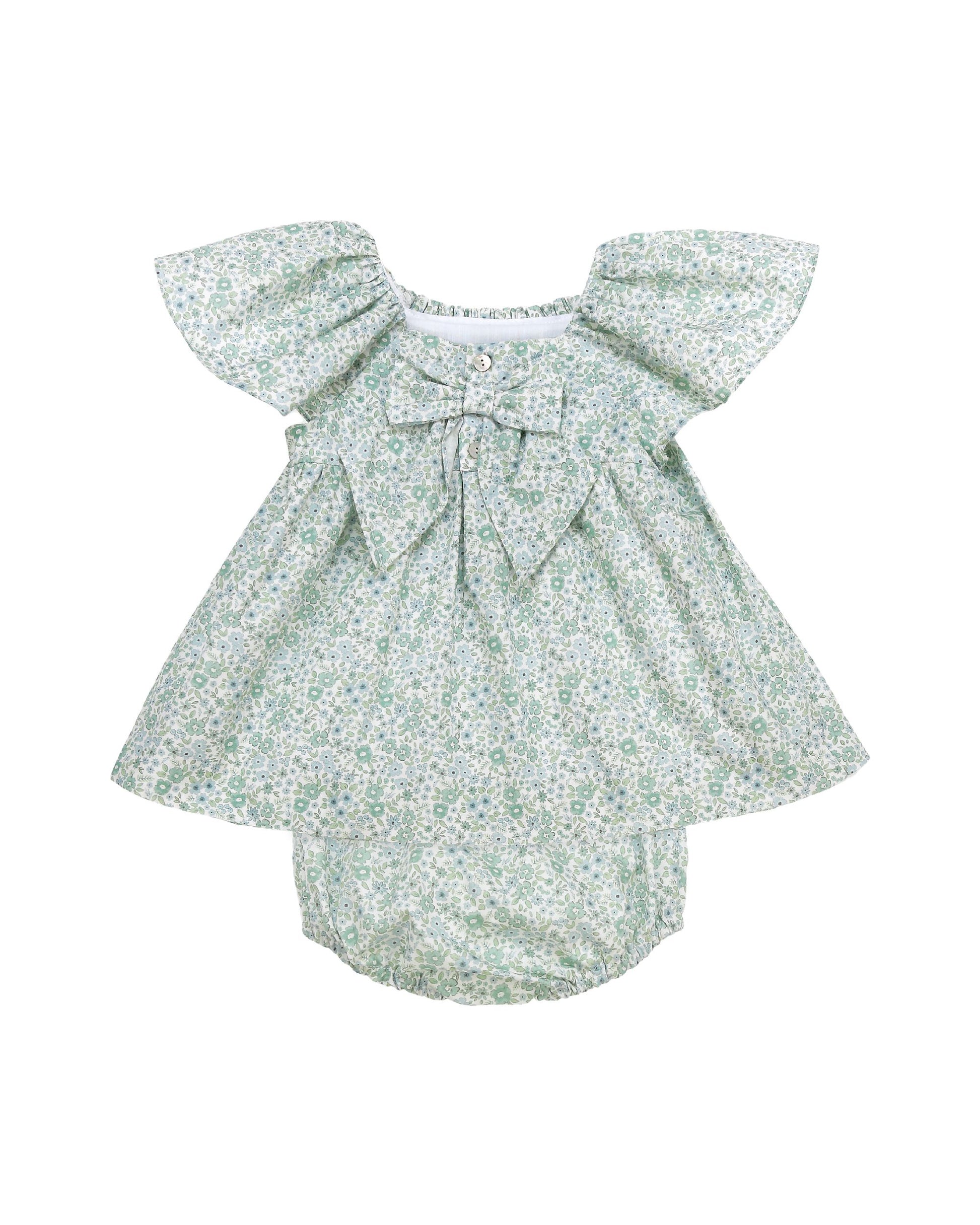 Back view of floral baby dress set with hand smocked neckline and flutter sleeves
