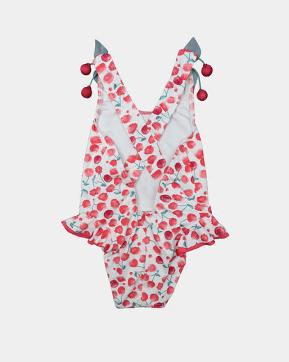 Back view of Al Agua Patos girls cherry swimsuit featuring crisscross straps and decorative cherry pom-pom ties.
