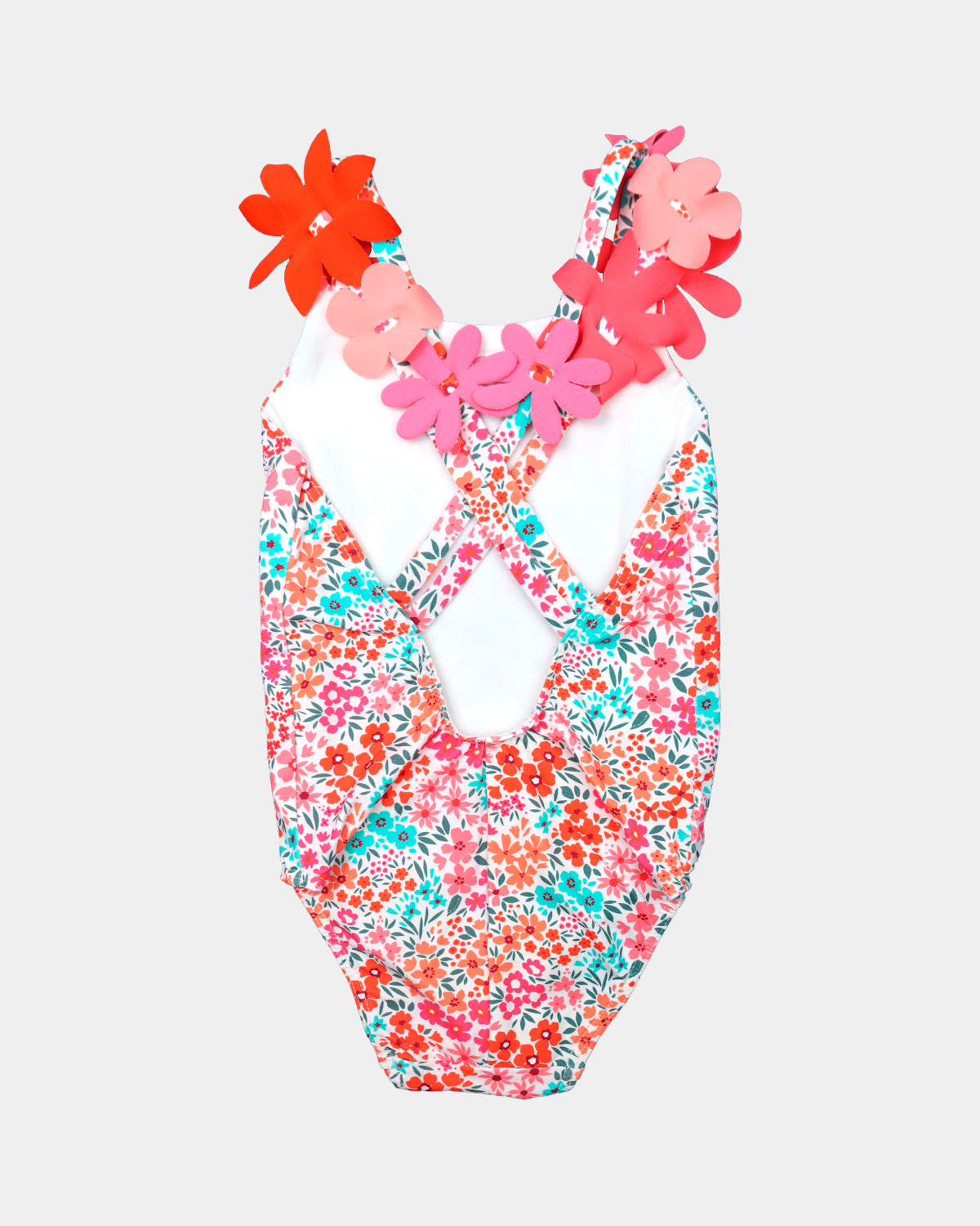 Back view of Al Agua Patos girls floral swimsuit featuring crisscross straps and decorative 3D flowers.