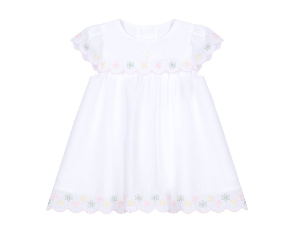 White baby girl dress with pastel floral embroidery, scalloped yoke, flutter sleeves, and scalloped hem.”